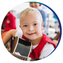 Pooled Special Needs Trust young boy with down syndrome playing guitar