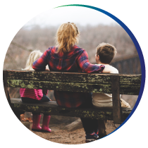 About-Secured-Futures—Our-Story-Thumb Young woman with two children sitting on bench
